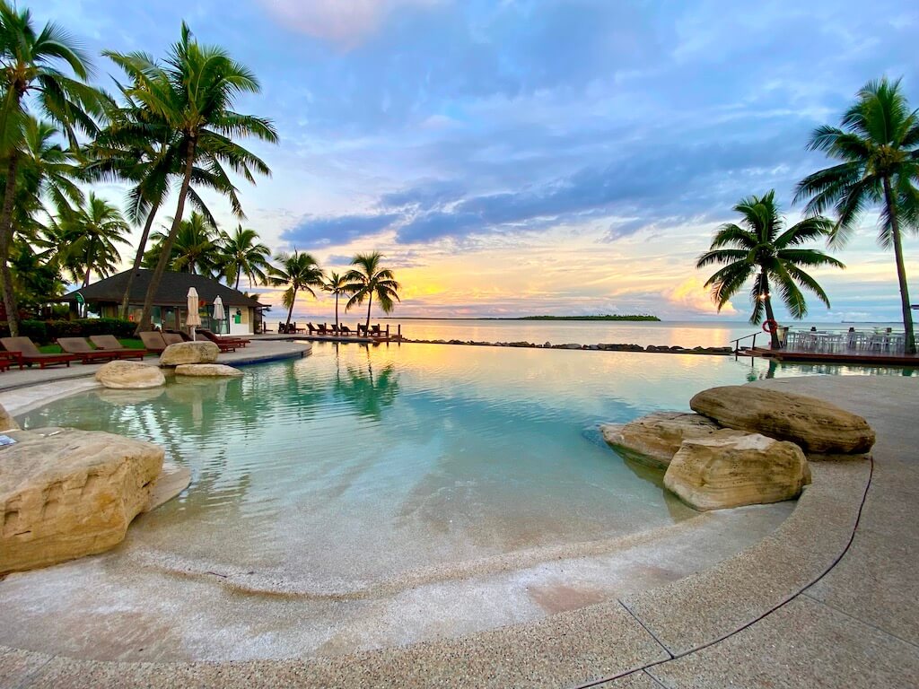 Aerial view of Sheraton Fiji Beach Resort pool and beach at sunset