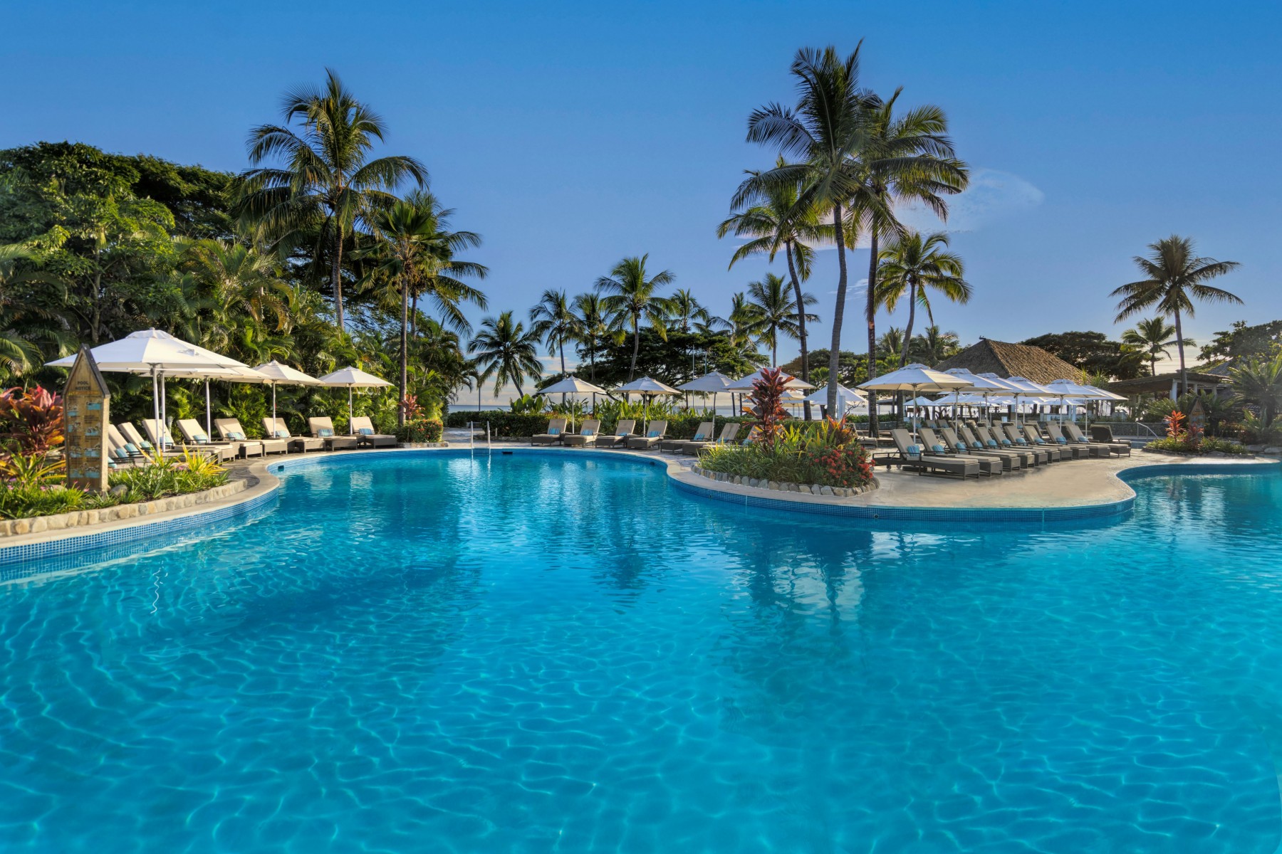 Aerial view of Sofitel Fiji Resort & Spa pool, palms and beachfront on Denarau Island